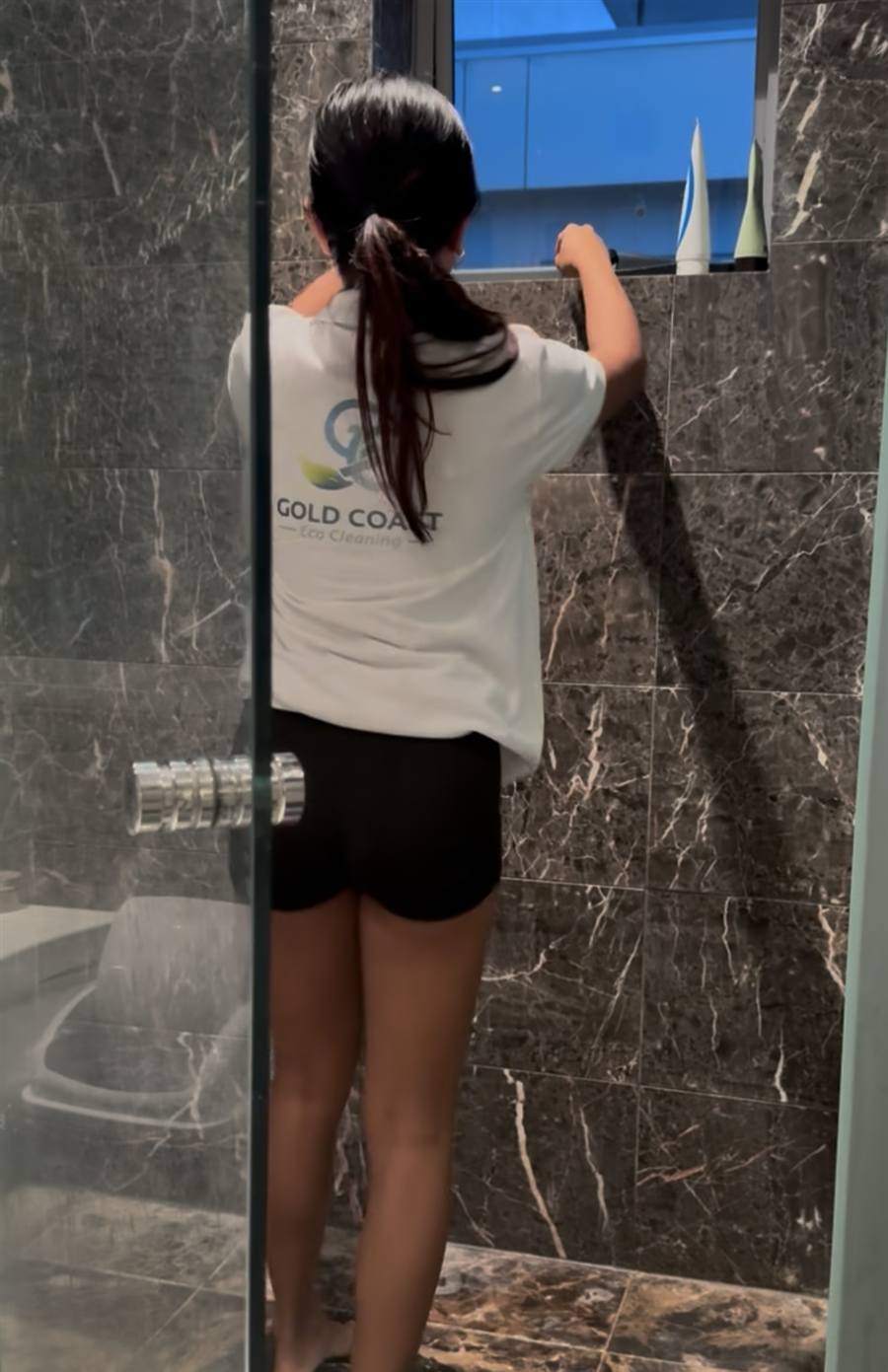 Gold Coast Eco Cleaning team member detailing a marble ensuite